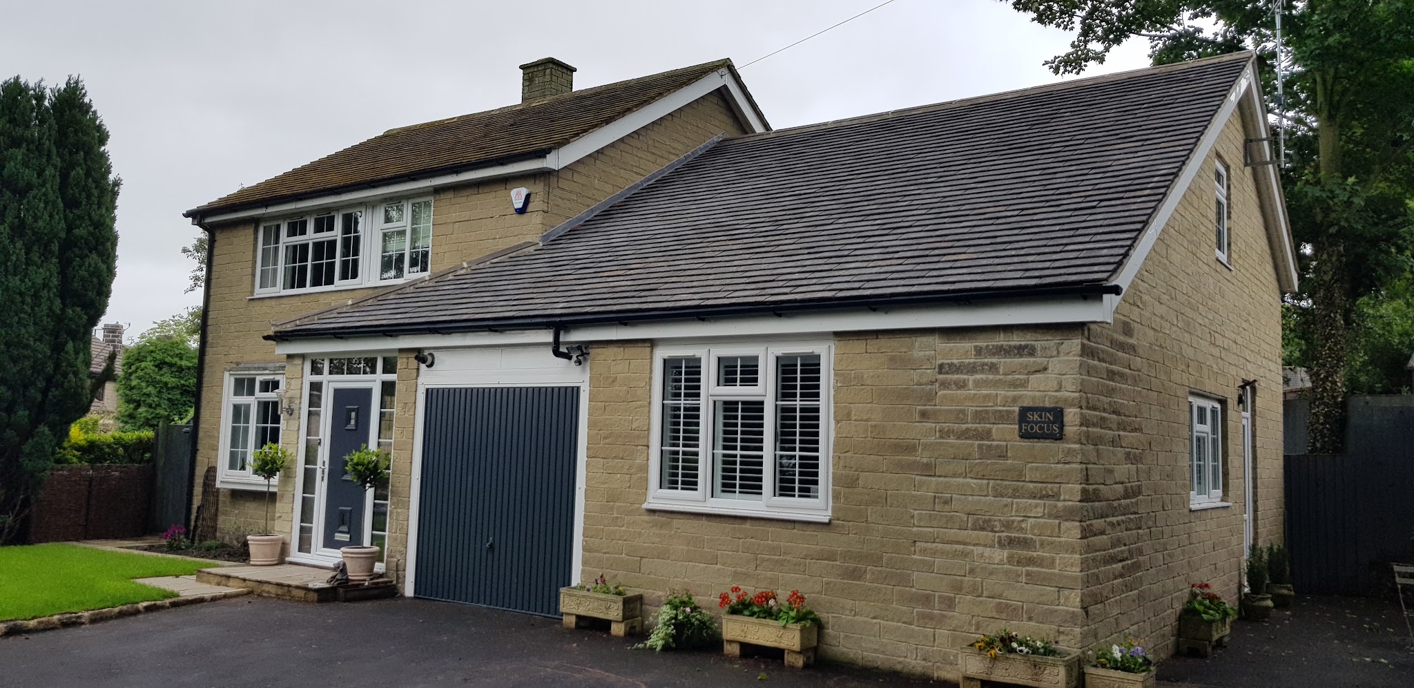 Skin Focus at Police House, with its slate sign beside the white windows