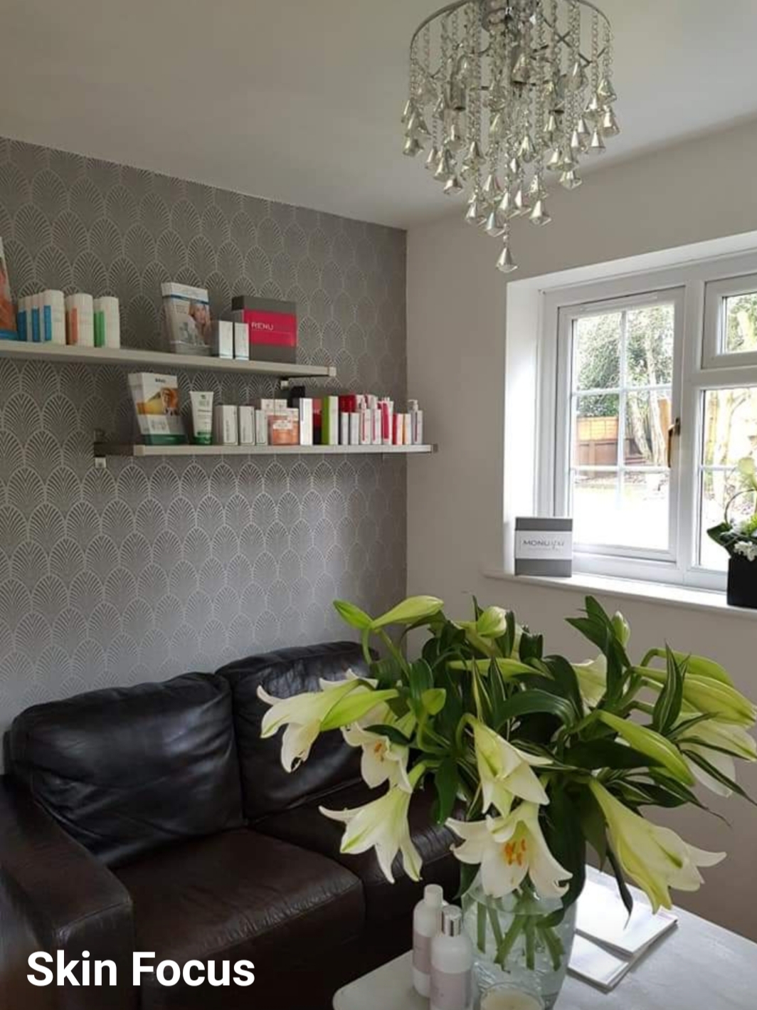 Flowers, comfortable seating and skin care shelves inside Skin Focus
